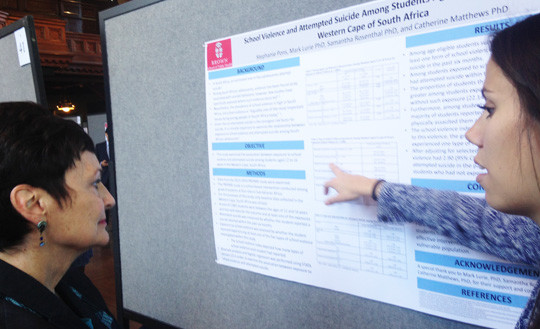 Dean Terrie Fox Wetle talks with one the 66 poster presenters about her research project at the 2016 Public Health Research Day.